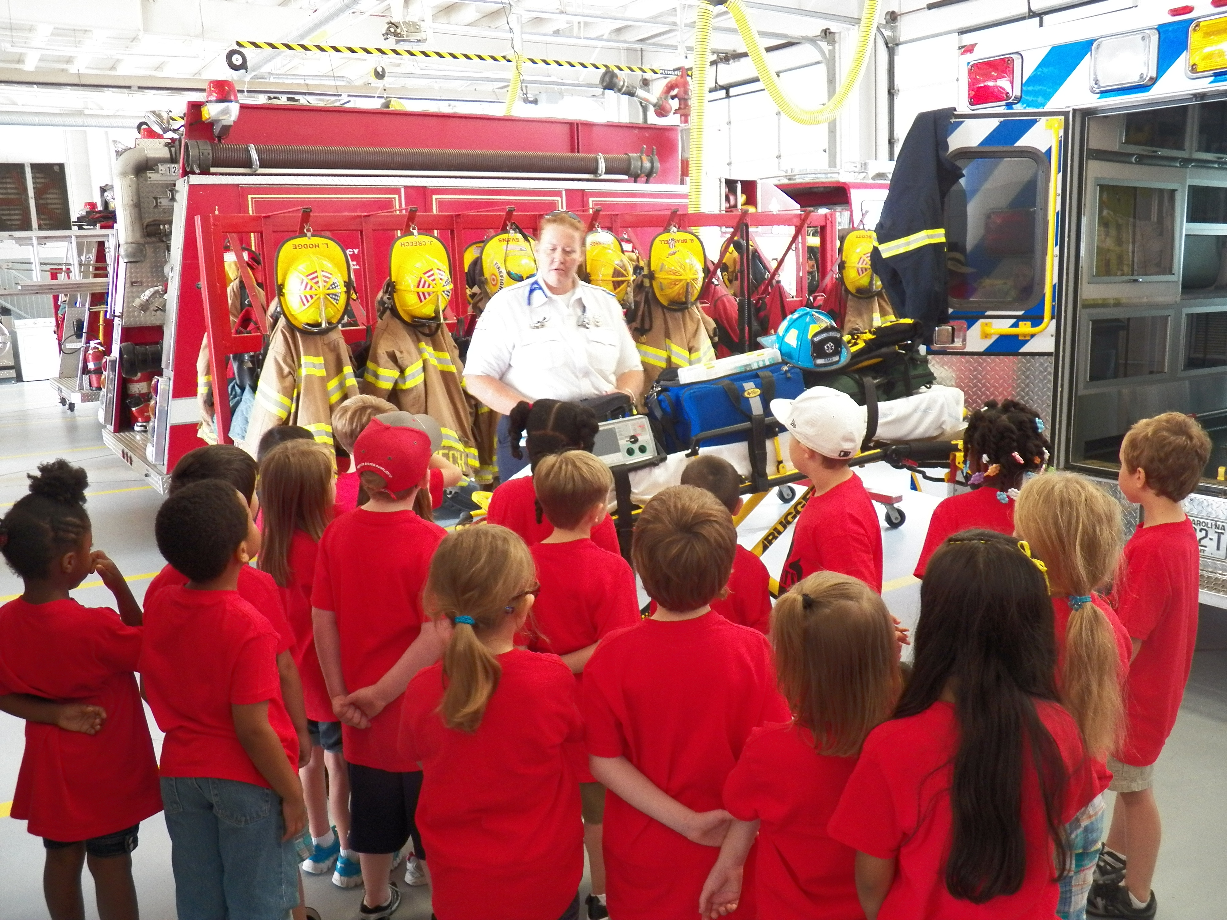 Kids visiting a station and touring the ambulances