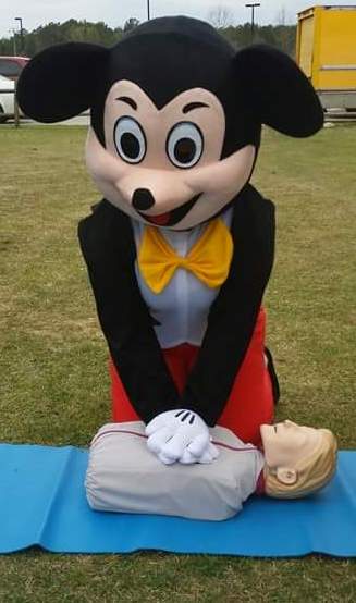 Mouse Mascot Performing CPR on Training Dummy