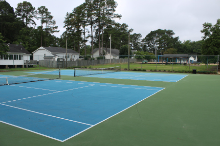 Refurbished tennis courts located in the back of the park