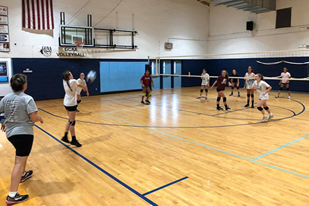 League volleyball players practicing for a game