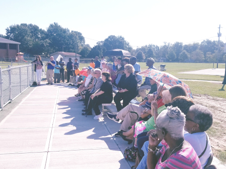 Stakeholders and the public at the grand opening/memorial for the tennis courts
