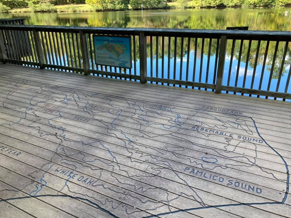 Pond deck with all of North Carolina's river basins carved into the base